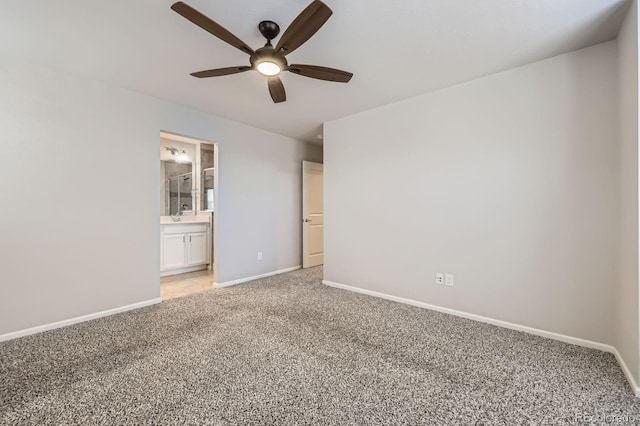 unfurnished room featuring light carpet, a ceiling fan, and baseboards