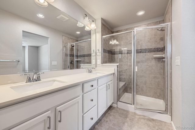 full bathroom featuring visible vents, a sink, and a shower stall