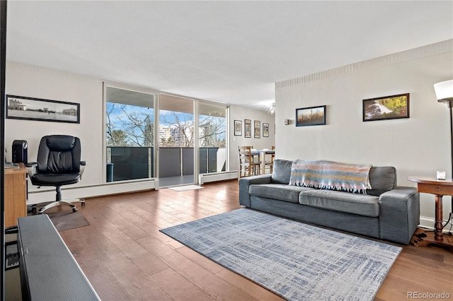 living room featuring expansive windows, a baseboard radiator, and hardwood / wood-style flooring