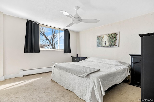 carpeted bedroom with ceiling fan, baseboard heating, and baseboards