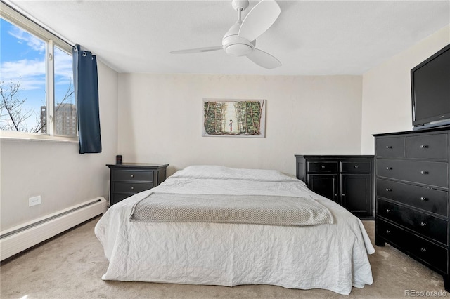 carpeted bedroom with a ceiling fan, baseboards, and baseboard heating