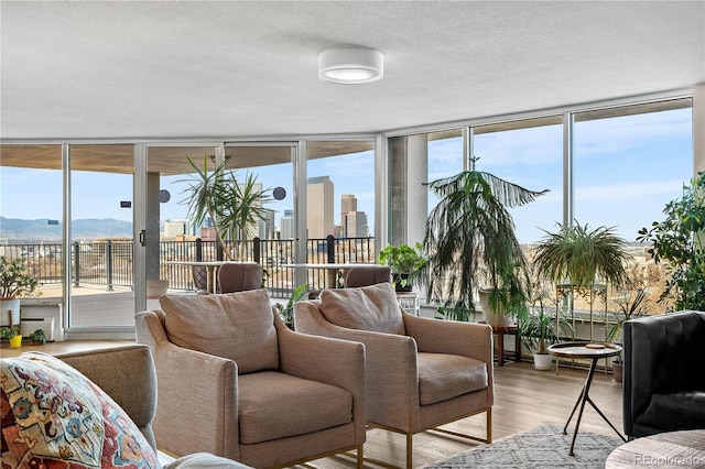 sunroom with a view of city, a healthy amount of sunlight, and a mountain view