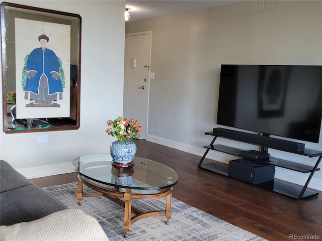 living room with baseboards and wood finished floors