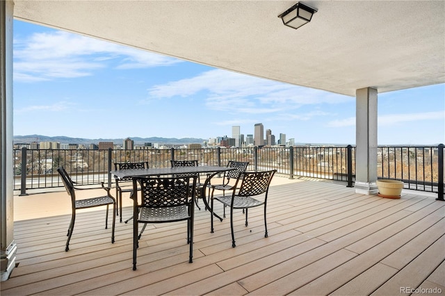 1085 N Lafayette St Unit 704, Denver, CO 80218 - wooden terrace with outdoor dining area, a mountain view, and a skyline view