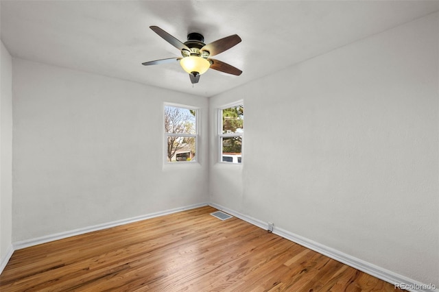 unfurnished room featuring baseboards, light wood-style floors, and ceiling fan