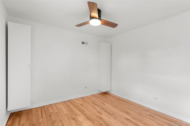 unfurnished room with light wood finished floors, baseboards, and ceiling fan
