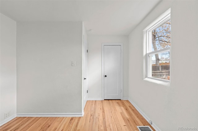 empty room with wood finished floors and baseboards