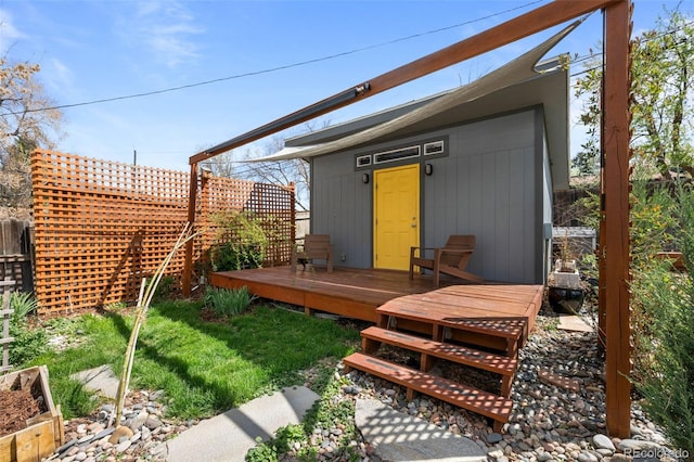 view of outbuilding featuring fence