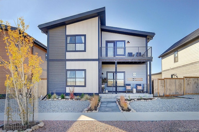 back of property with a porch and a balcony