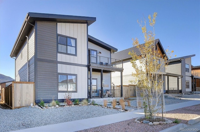 contemporary house featuring a balcony and a porch