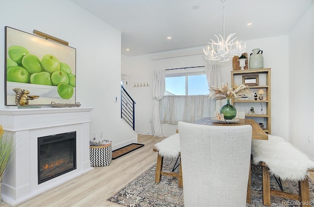 dining space with a chandelier and light wood-type flooring