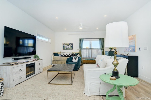 living room with ceiling fan and light wood-type flooring