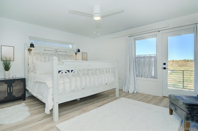 bedroom with wood-type flooring, access to exterior, and ceiling fan