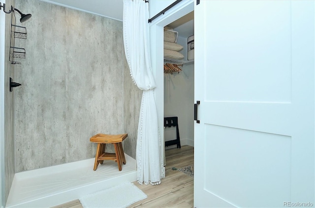 bathroom featuring wood-type flooring and a shower