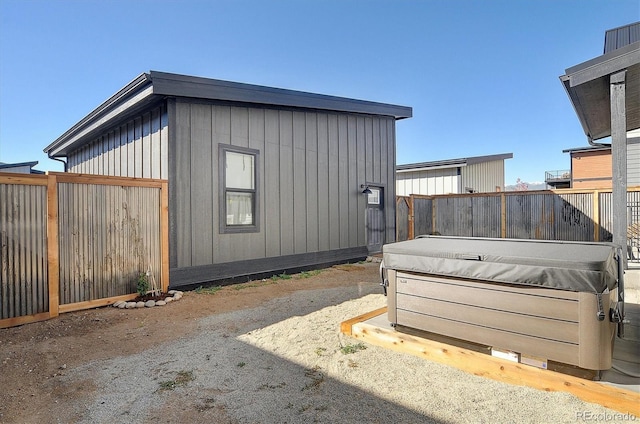 view of home's exterior featuring a hot tub