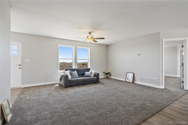 living room featuring ceiling fan and hardwood / wood-style flooring