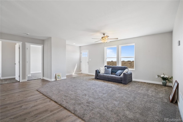 living room featuring wood-type flooring and ceiling fan