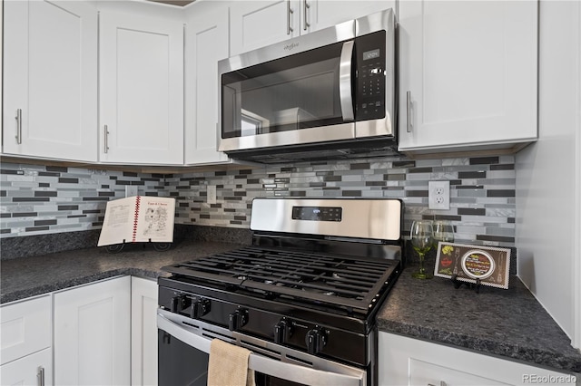 kitchen with appliances with stainless steel finishes, backsplash, and white cabinetry