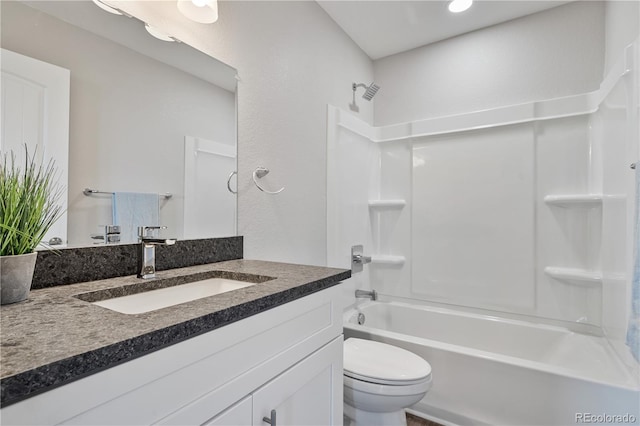 full bathroom featuring bathtub / shower combination, vanity, and toilet