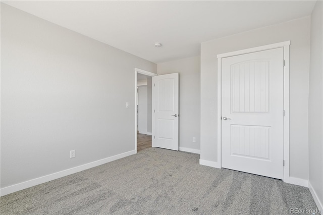 unfurnished bedroom featuring a closet and carpet floors