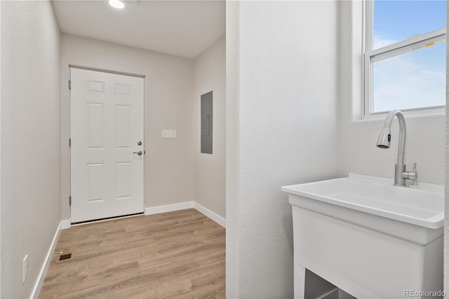 washroom with sink and light hardwood / wood-style flooring