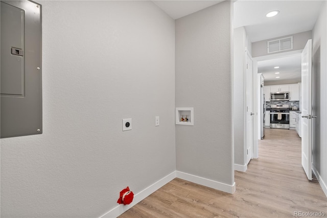 laundry room featuring hookup for an electric dryer, light hardwood / wood-style floors, and washer hookup