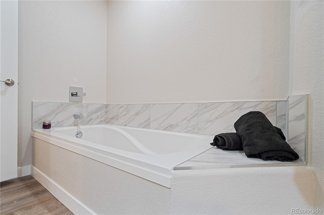 bathroom featuring hardwood / wood-style floors and a bathtub