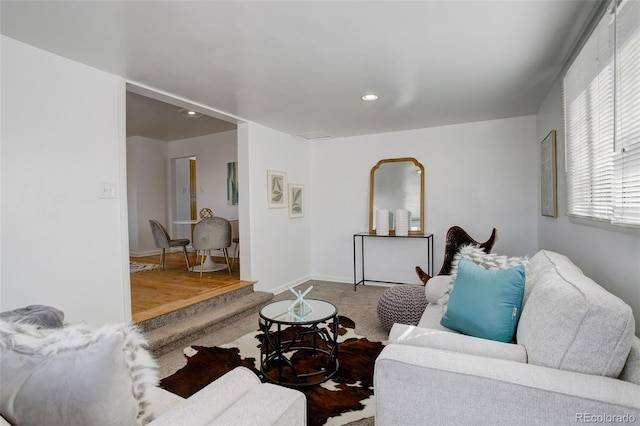 living area with carpet, baseboards, and recessed lighting