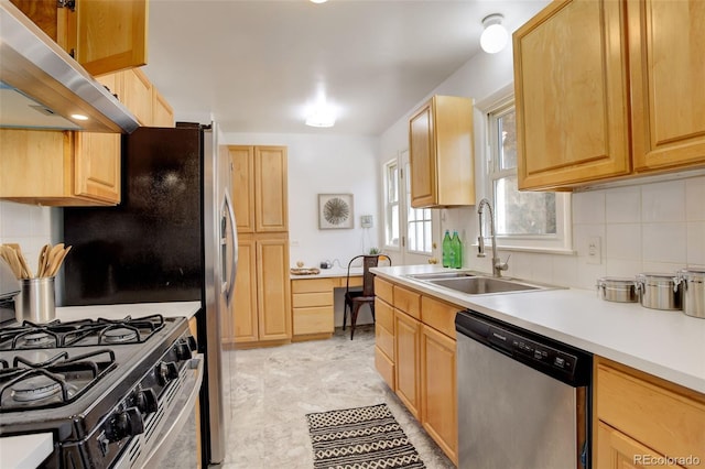 kitchen with gas range oven, tasteful backsplash, stainless steel dishwasher, a sink, and under cabinet range hood