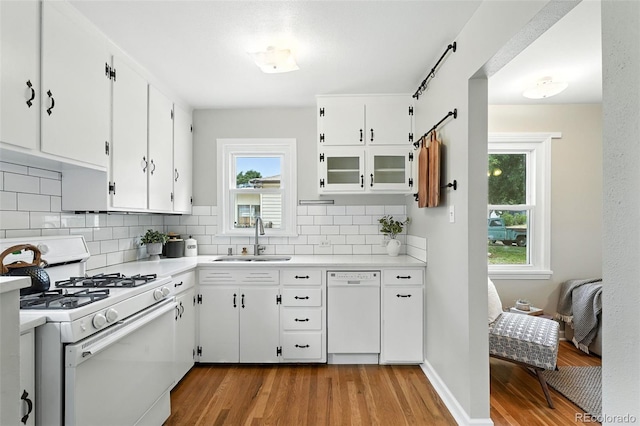 2000 S King St, Denver, CO 80219 - kitchen featuring white appliances, light wood-style floors, light countertops, and backsplash