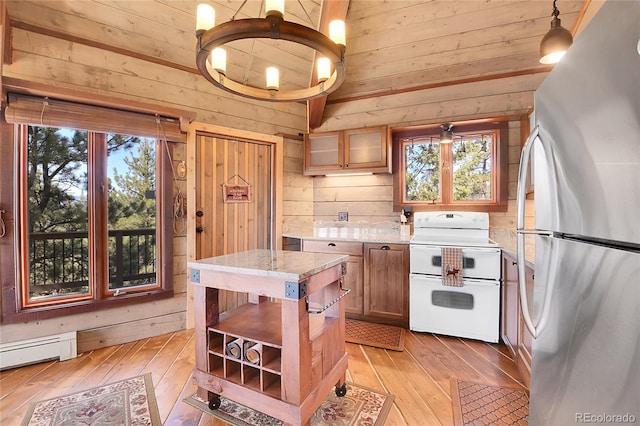 693 Rd C, Pine, CO 80470 - kitchen featuring freestanding refrigerator, range with two ovens, open shelves, wooden walls, and vaulted ceiling