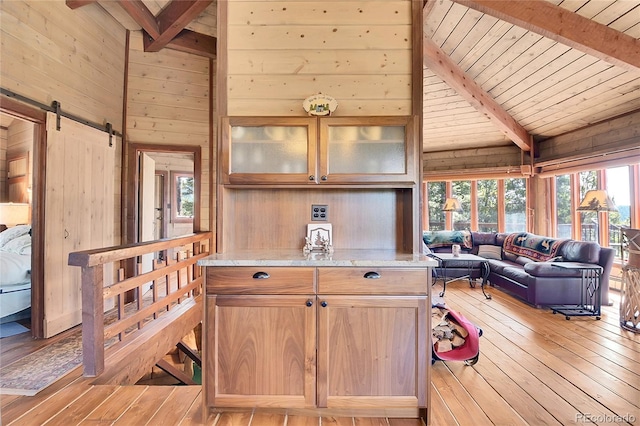 693 Rd C, Pine, CO 80470 - kitchen featuring wooden walls, wooden ceiling, light wood finished floors, a barn door, and open floor plan