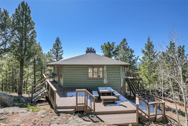 693 Rd C, Pine, CO 80470 - rear view of house featuring stairs, a deck, a chimney, and roof with shingles