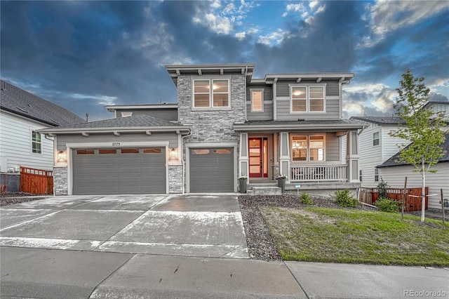 2775 Morningbird Ln, Castle Rock, CO 80109 - view of front of house featuring stone siding, a porch, driveway, and an attached garage