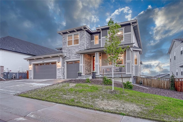 2775 Morningbird Ln, Castle Rock, CO 80109 - view of front of house featuring stone siding, a porch, and driveway