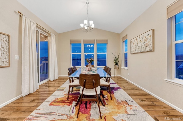 2775 Morningbird Ln, Castle Rock, CO 80109 - dining space featuring hardwood / wood-style flooring, a chandelier, lofted ceiling, and baseboards