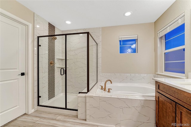 2775 Morningbird Ln, Castle Rock, CO 80109 - full bathroom with a garden tub, a marble finish shower, vanity, and recessed lighting