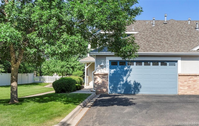 9168 W 50th Ln Unit 1, Arvada, CO 80002 - view of front of home featuring brick siding, asphalt driveway, a shingled roof, stucco siding, and a garage