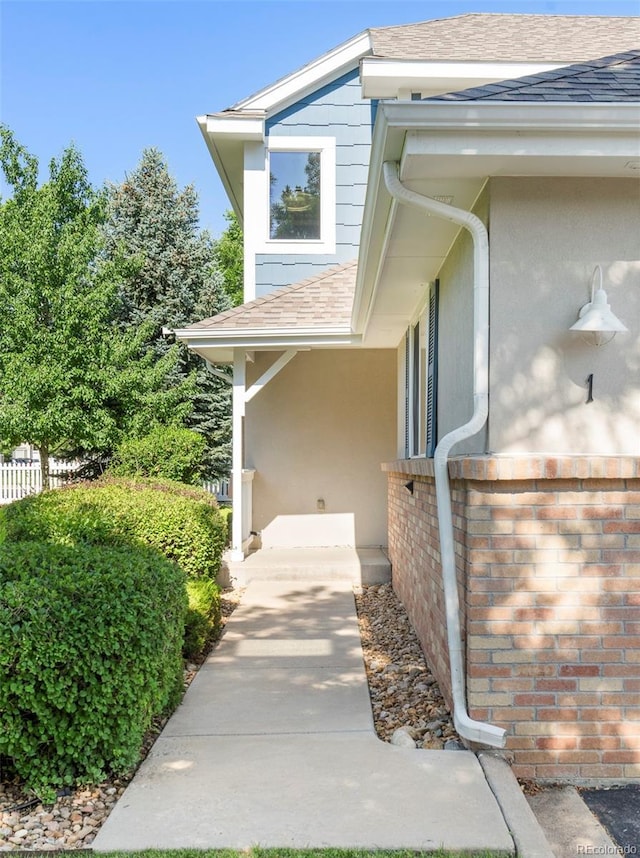 9168 W 50th Ln Unit 1, Arvada, CO 80002 - property entrance featuring roof with shingles and stucco siding