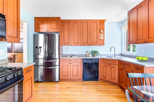 9168 W 50th Ln Unit 1, Arvada, CO 80002 - kitchen with black appliances, light wood-type flooring, light countertops, and recessed lighting