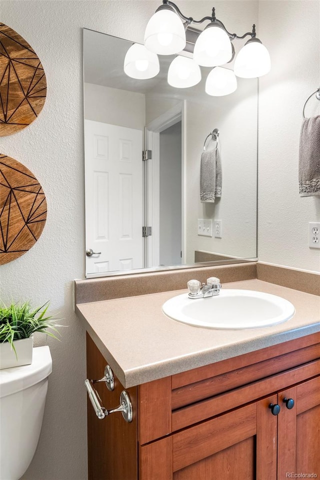 9168 W 50th Ln Unit 1, Arvada, CO 80002 - half bathroom with vanity and a textured wall