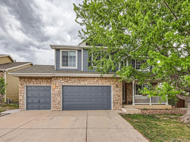 5163 Apache Creek Rd, Castle Rock, CO 80109 - view of front facade with concrete driveway, stone siding, and covered porch