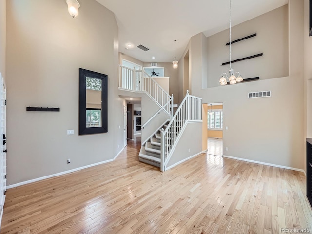 5163 Apache Creek Rd, Castle Rock, CO 80109 - foyer with a high ceiling, stairs, wood-type flooring, baseboards, and a chandelier