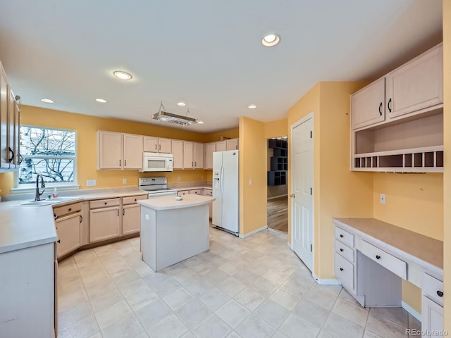 5163 Apache Creek Rd, Castle Rock, CO 80109 - kitchen featuring white appliances, light countertops, a kitchen island, a sink, and recessed lighting