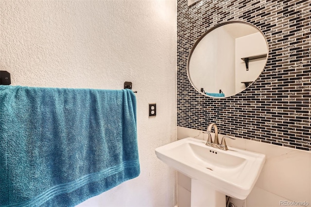 5163 Apache Creek Rd, Castle Rock, CO 80109 - bathroom featuring tile walls, tasteful backsplash, a sink, and a textured wall