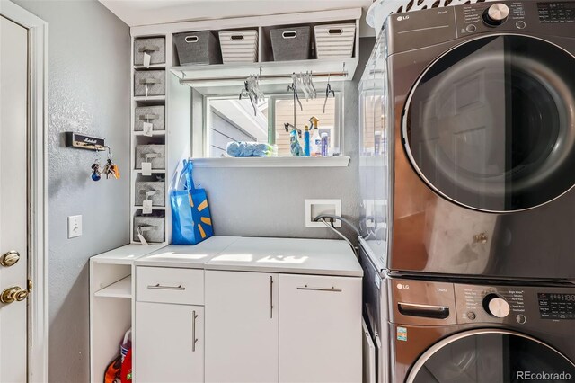 5163 Apache Creek Rd, Castle Rock, CO 80109 - clothes washing area with cabinet space and estacked washer and dryer