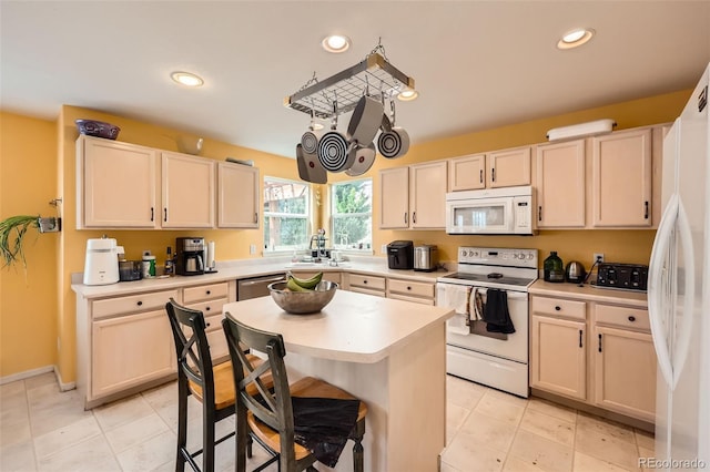 5163 Apache Creek Rd, Castle Rock, CO 80109 - kitchen with white appliances, light countertops, recessed lighting, a center island, and a breakfast bar