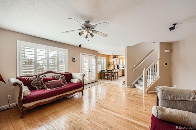 5163 Apache Creek Rd, Castle Rock, CO 80109 - living area featuring a ceiling fan, stairs, light wood-style floors, and baseboards