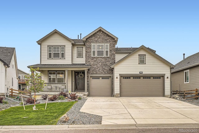 1403 Hart Ln, Elizabeth, CO 80107 - view of front of home with covered porch, driveway, stone siding, a front lawn, and a shingled roof