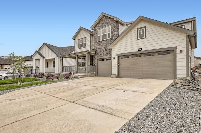 1403 Hart Ln, Elizabeth, CO 80107 - view of front of home with covered porch, concrete driveway, stone siding, board and batten siding, and a garage
